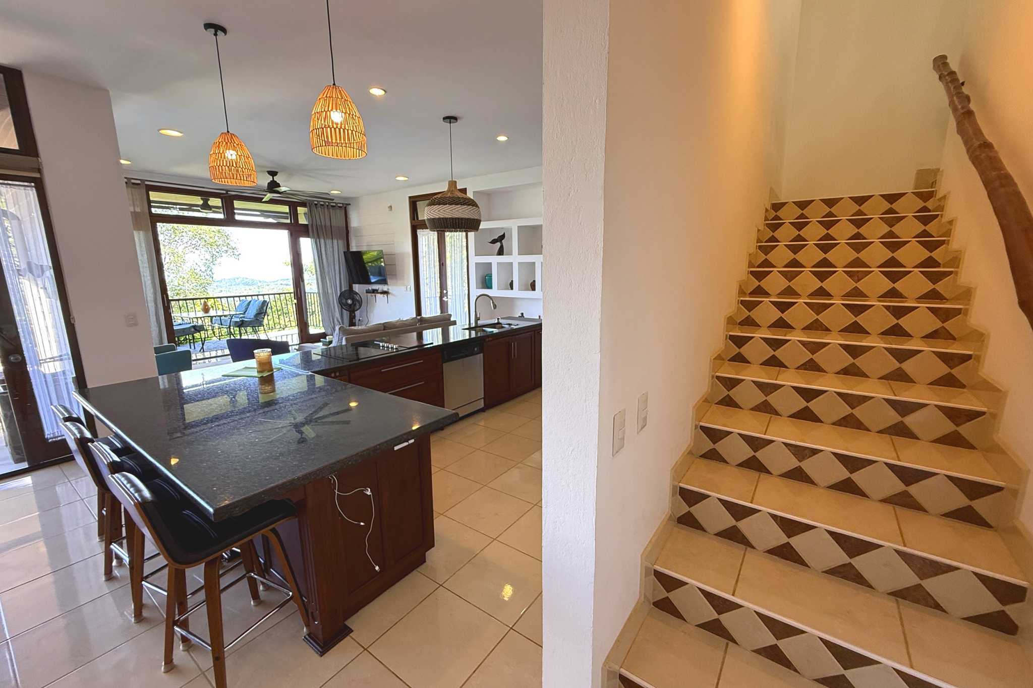 Panoramic Ocean View Home kitchen island with patterned tile staircase in Ojochal, Costa Rica