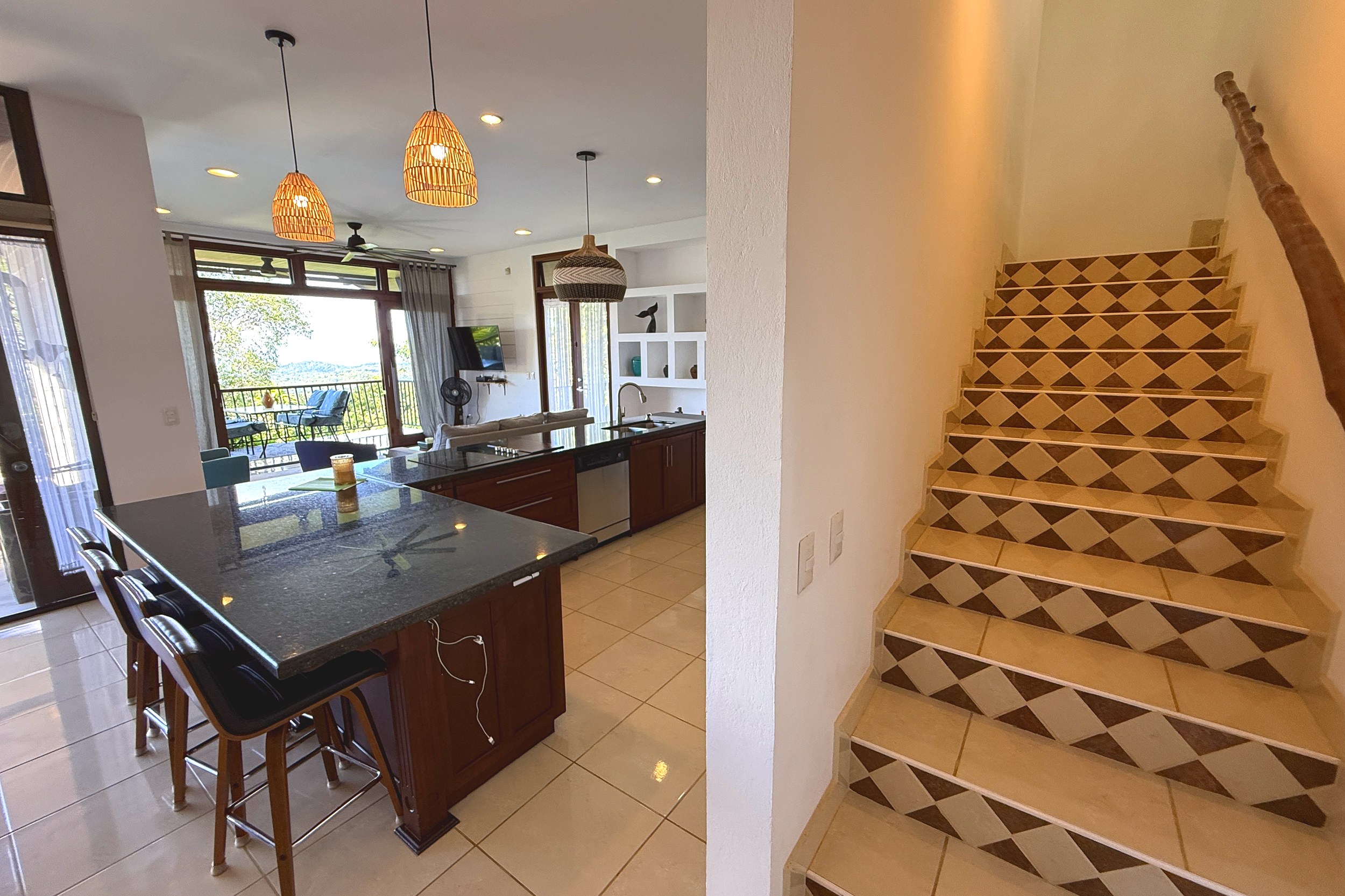 Kitchen & Tiled Staircase Panoramic Ocean View Home kitchen island with patterned tile staircase in Ojochal, Costa Rica