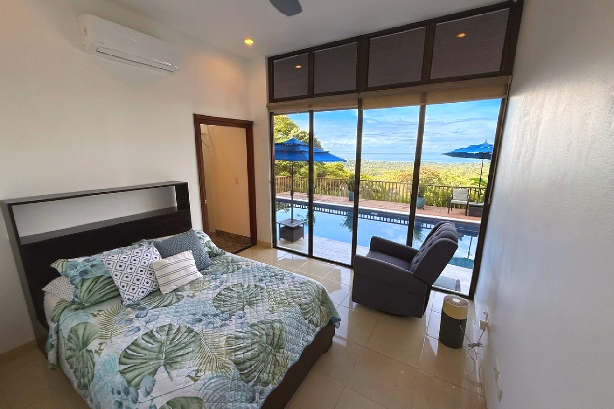 Downstairs Guest Bedroom with en suite & Ocean View Panoramic Ocean View Home bedroom with pool and ocean view in Ojochal, Costa Rica.