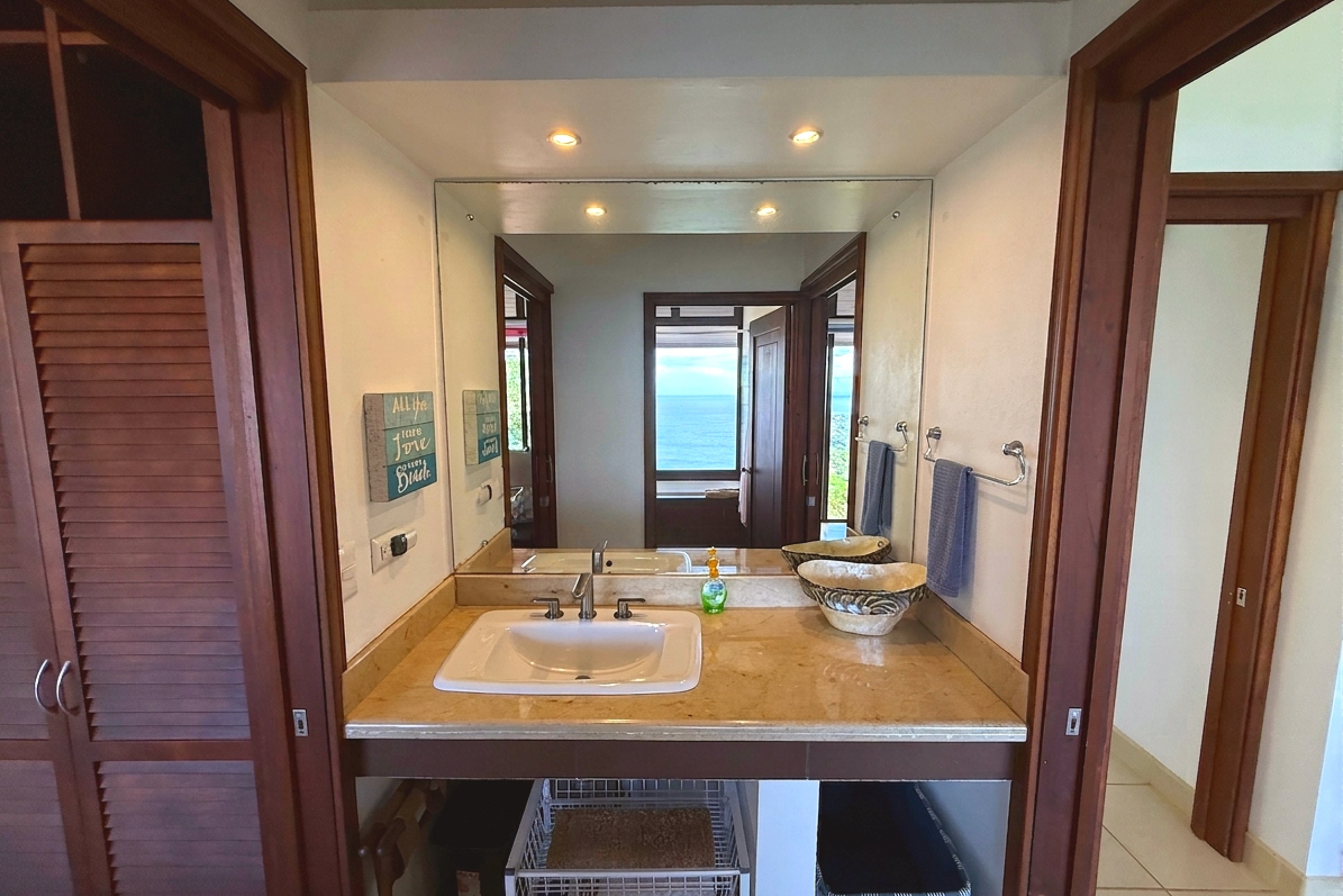 Guest Bathroom Vanity Ocean View Home guest bathroom with marble vanity and mirror in Ojochal, Costa Rica