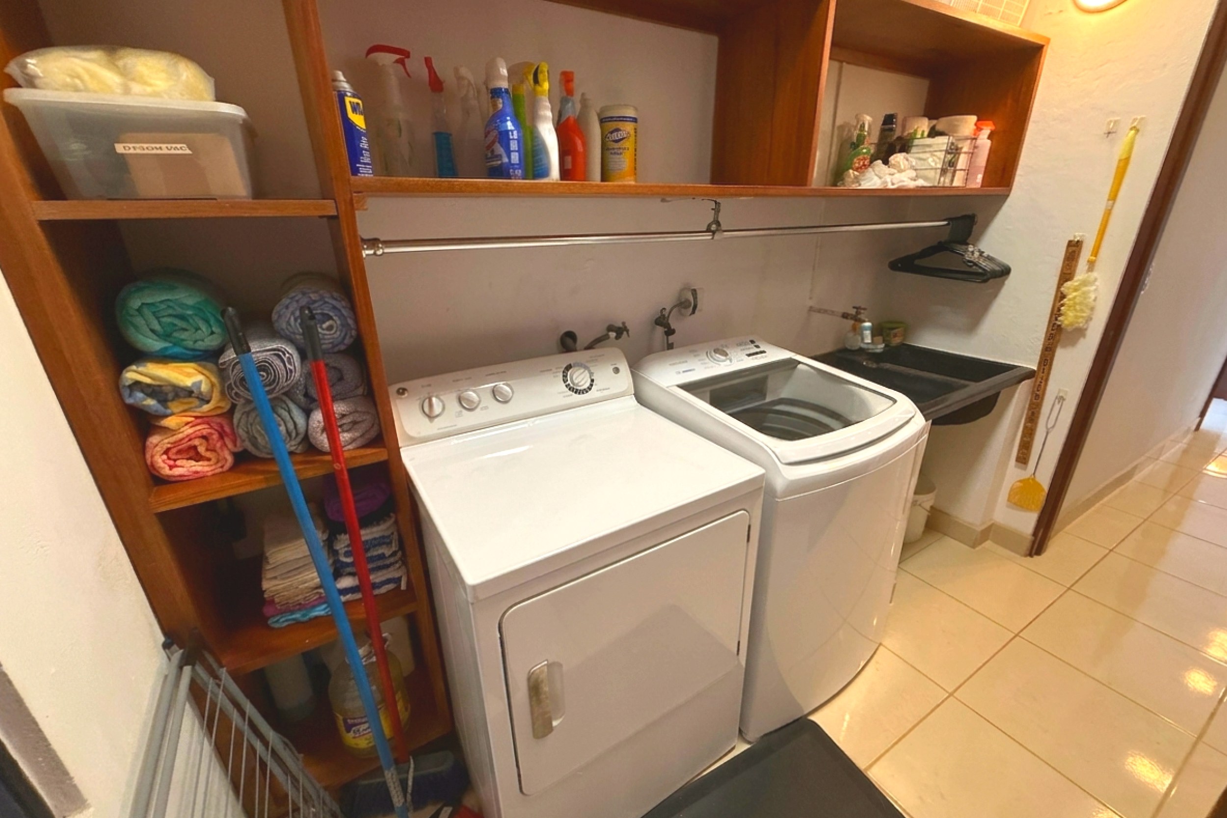 Laundry & Utility Room Ocean View Home laundry room with washer, dryer and storage shelves in Ojochal, Costa Rica