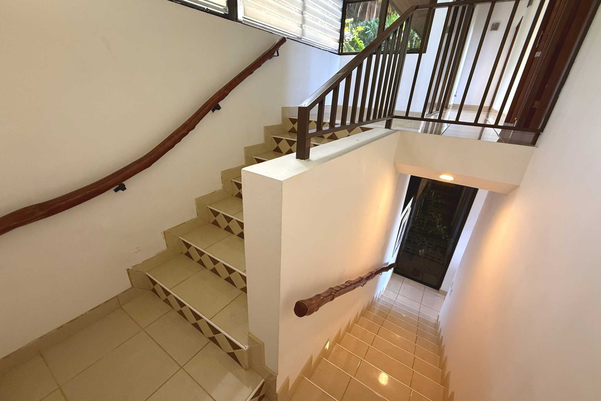 Ocean View Home tiled staircase with wood handrails in Ojochal, Costa Rica