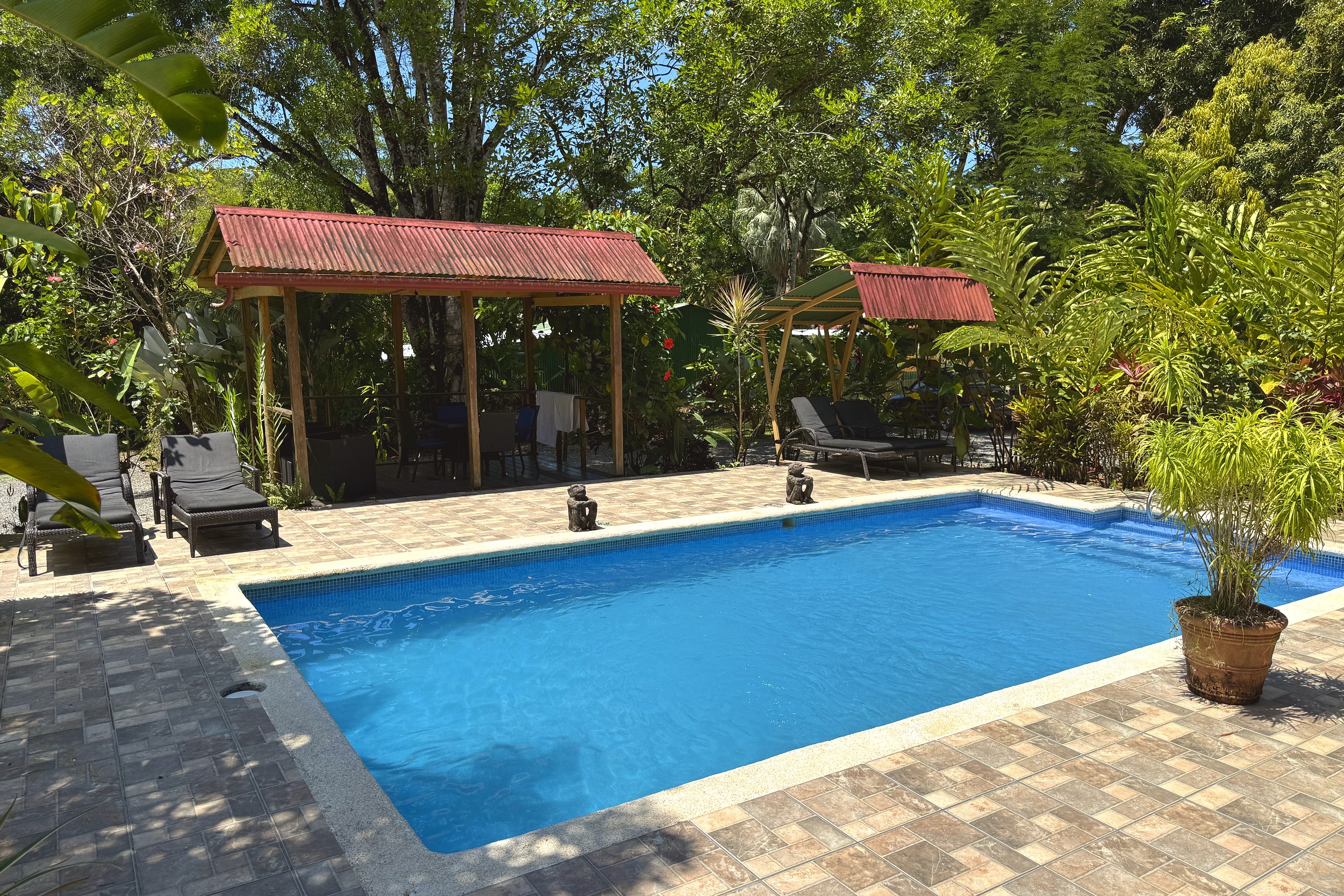 Pool & Palapa Lounge Area Jungle Hotel sparkling pool with poolside palapas and loungers in Ojochal, Costa Rica