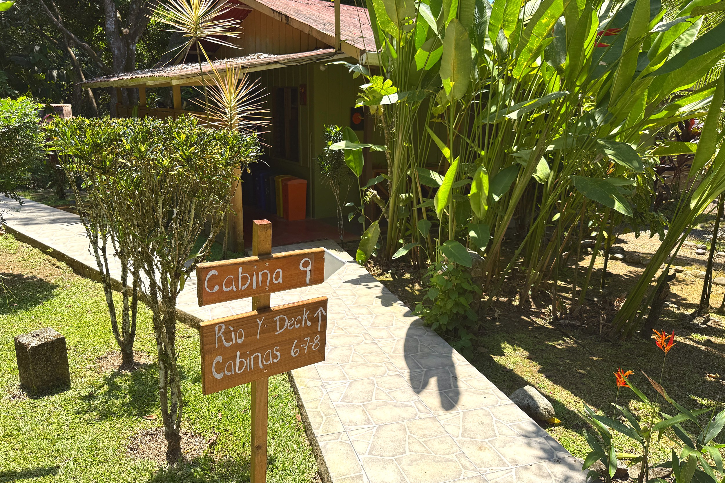 Cabina Pathway & Signage Jungle Hotel wooden cabina sign along tiled garden path in Ojochal, Costa Rica