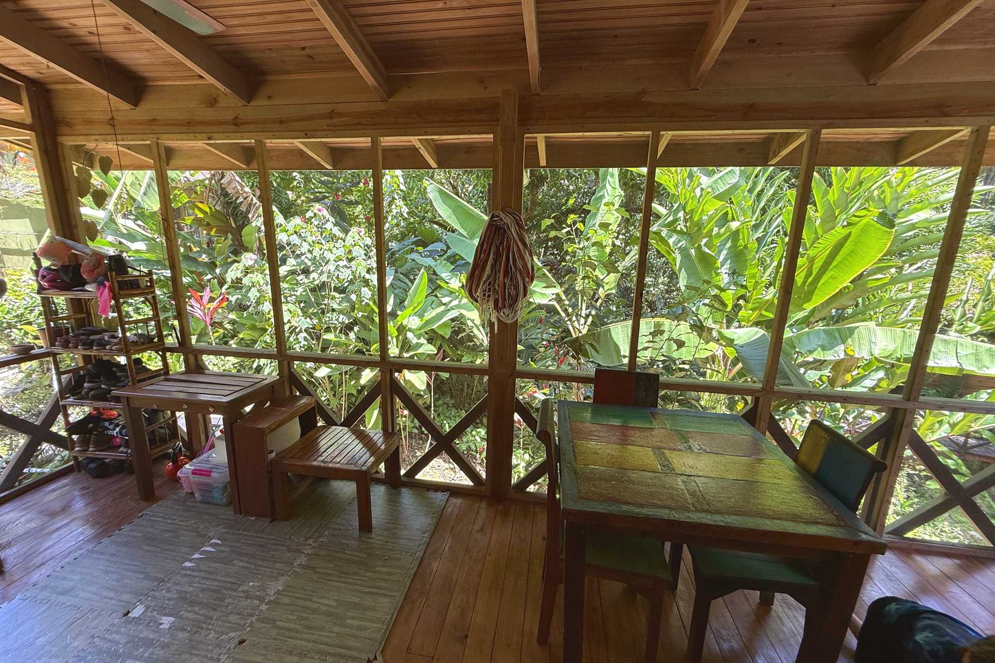 Jungle Hotel screened porch dining area with jungle views in Ojochal, Costa Rica