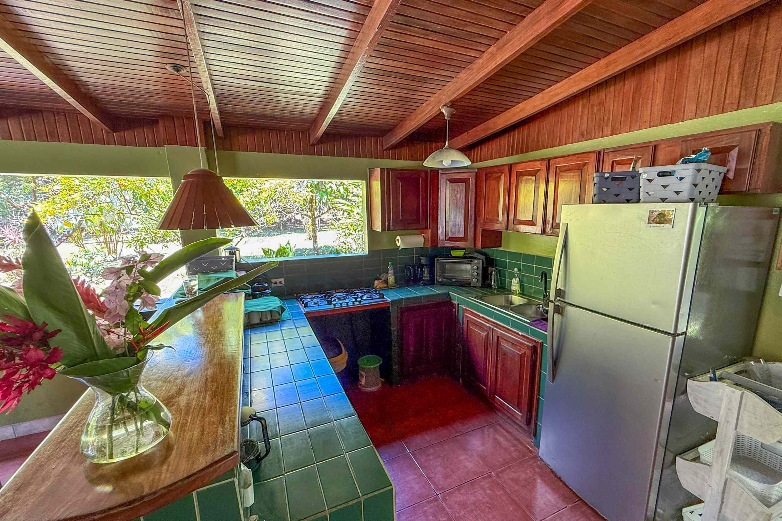 Rustic Jungle Kitchen Jungle Hotel green tiled kitchen with wood cabinets in Ojochal, Costa Rica