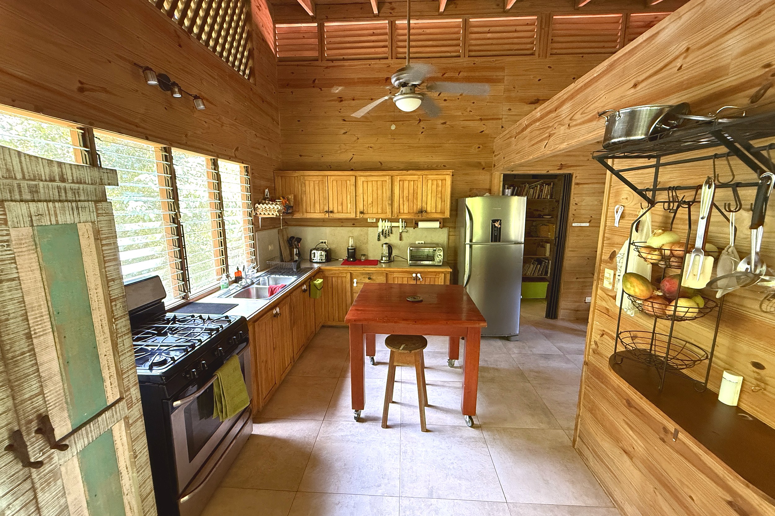 Rustic Wood Kitchen & Island Jungle Hotel wooden kitchen with island and gas stove in Ojochal, Costa Rica