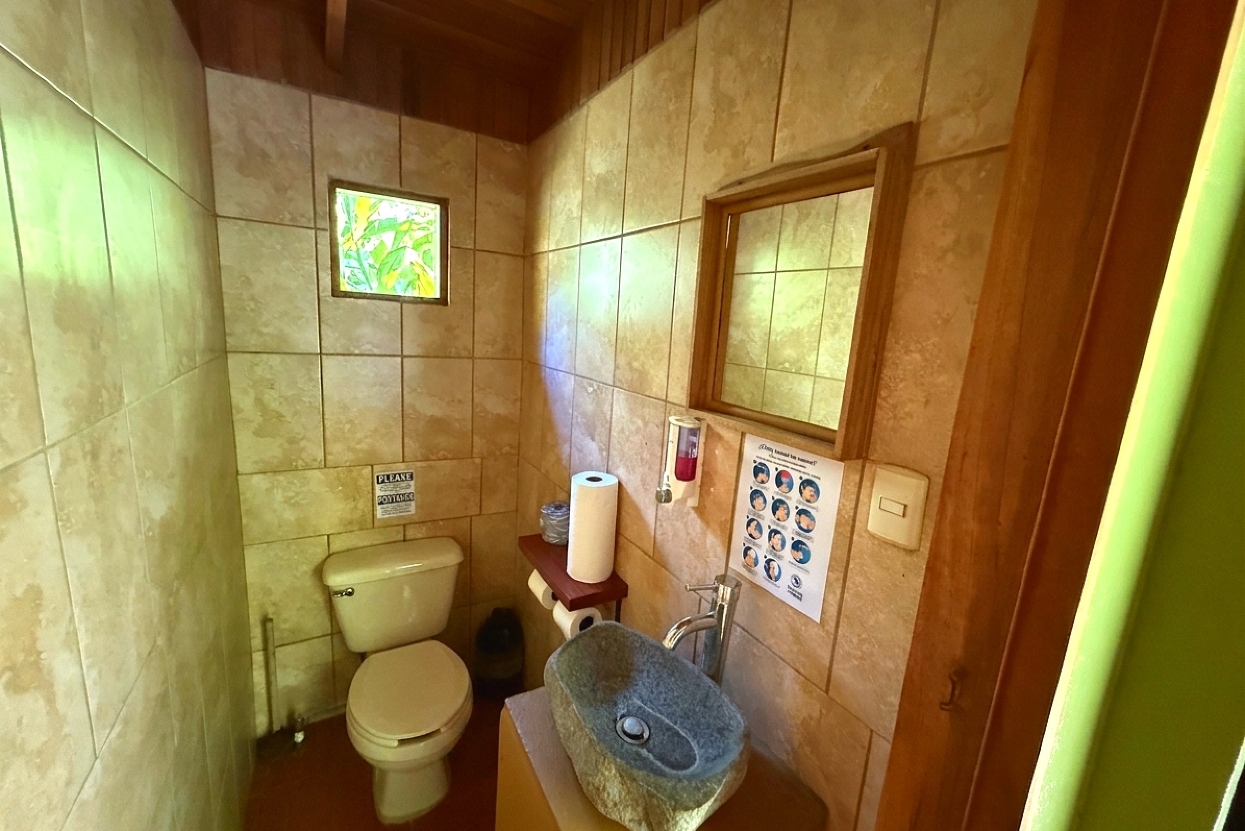 Guest Half Bathroom with Stone Sink Jungle Hotel tiled bathroom with stone vessel sink in Ojochal, Costa Rica