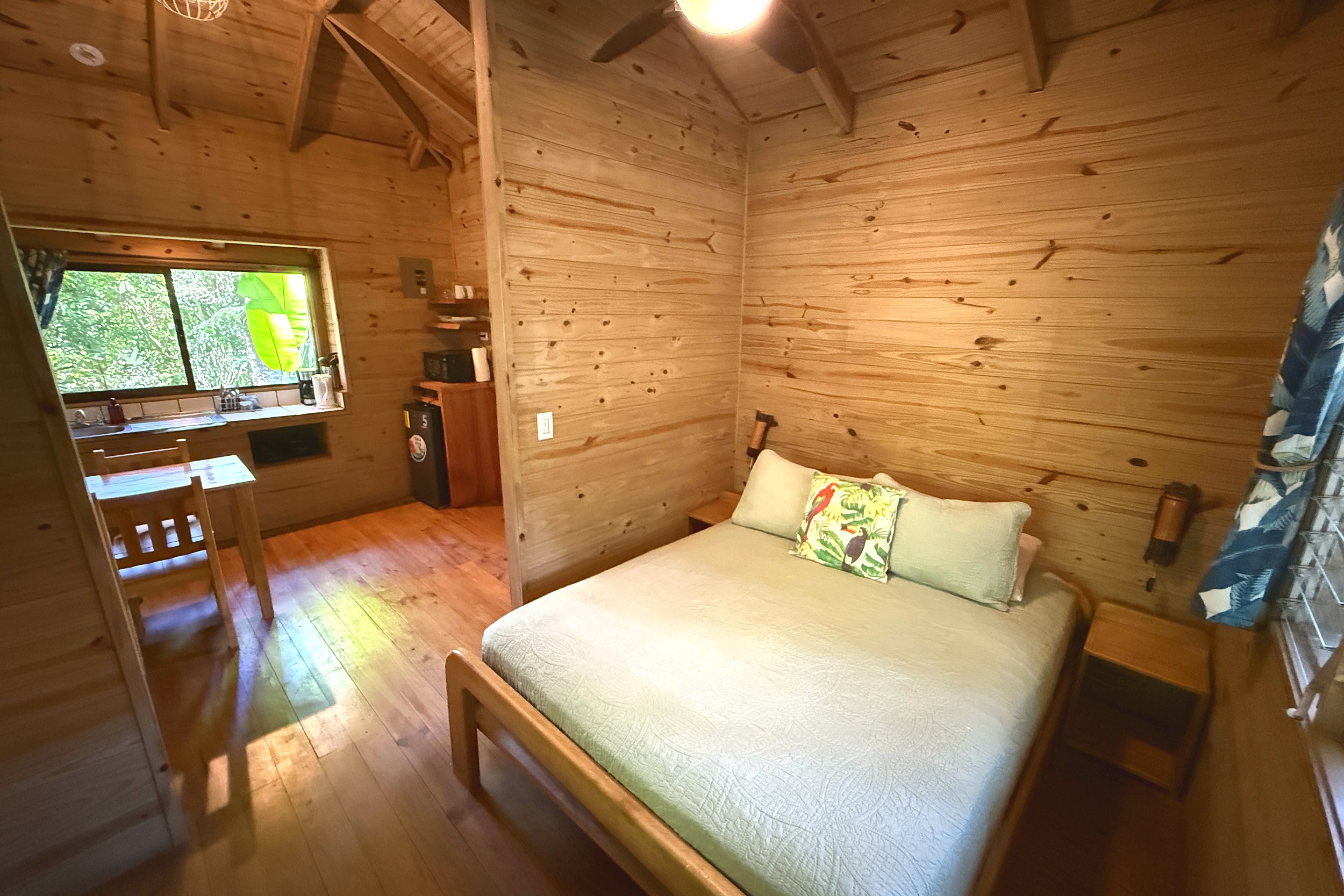 Cozy Wooden Guest Bedroom Jungle Hotel wooden guesthouse bedroom with queen bed in Ojochal, Costa Rica