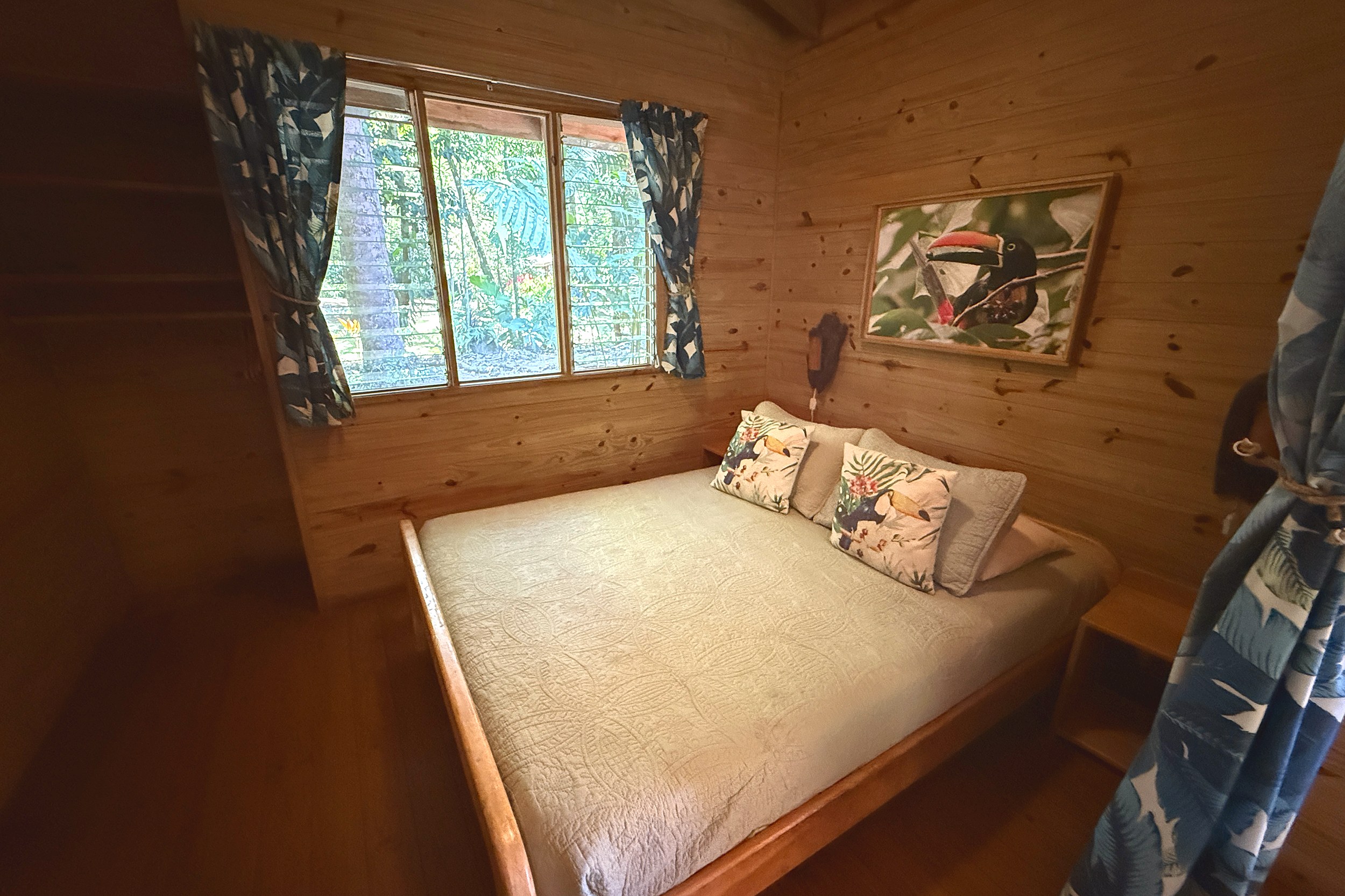 Cozy Wooden Guest Bedroom Jungle Hotel guest bedroom with wood walls and jungle view in Ojochal, Costa Rica
