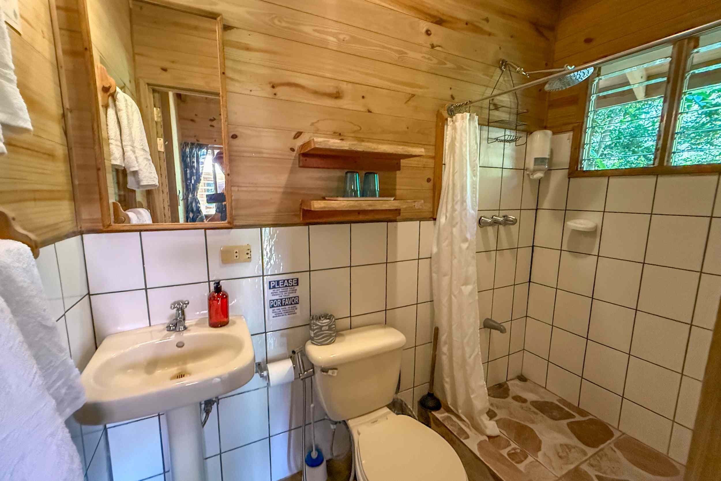 Rustic Wood Guest Bathroom Jungle Hotel wood-paneled guest bathroom with tiled shower in Ojochal, Costa Rica