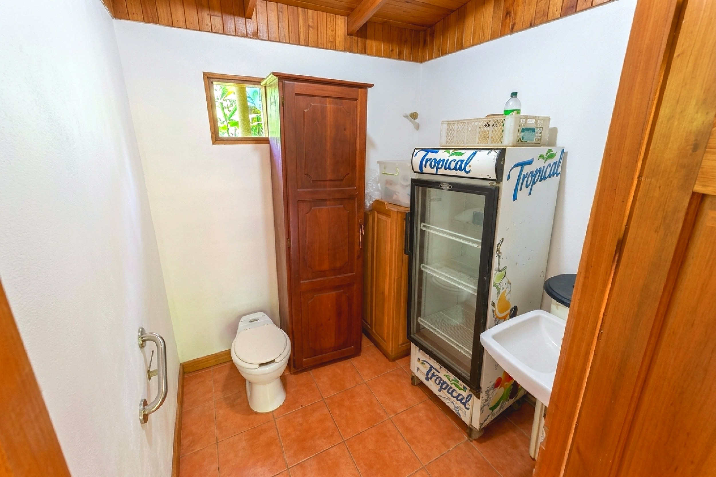 Utility Room & Storage Jungle Hotel utility room with toilet, sink and beverage fridge in Ojochal, Costa Rica