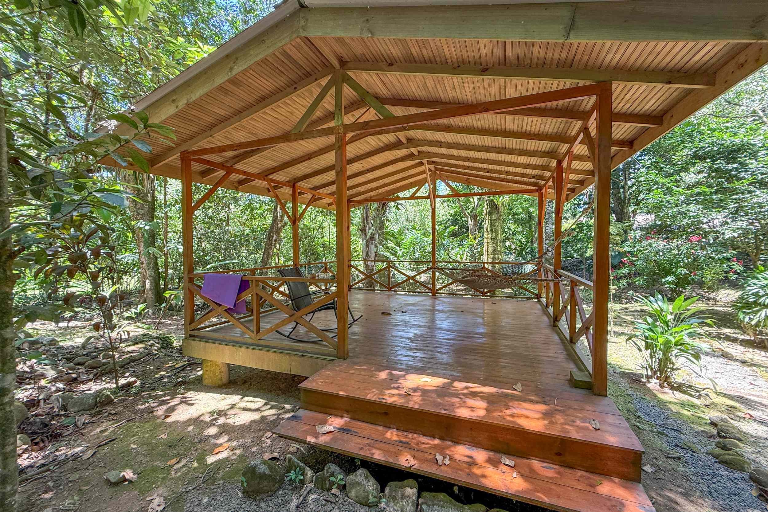 Open-Air Jungle Pavilion Jungle Hotel wooden pavilion deck with hammock in Ojochal, Costa Rica