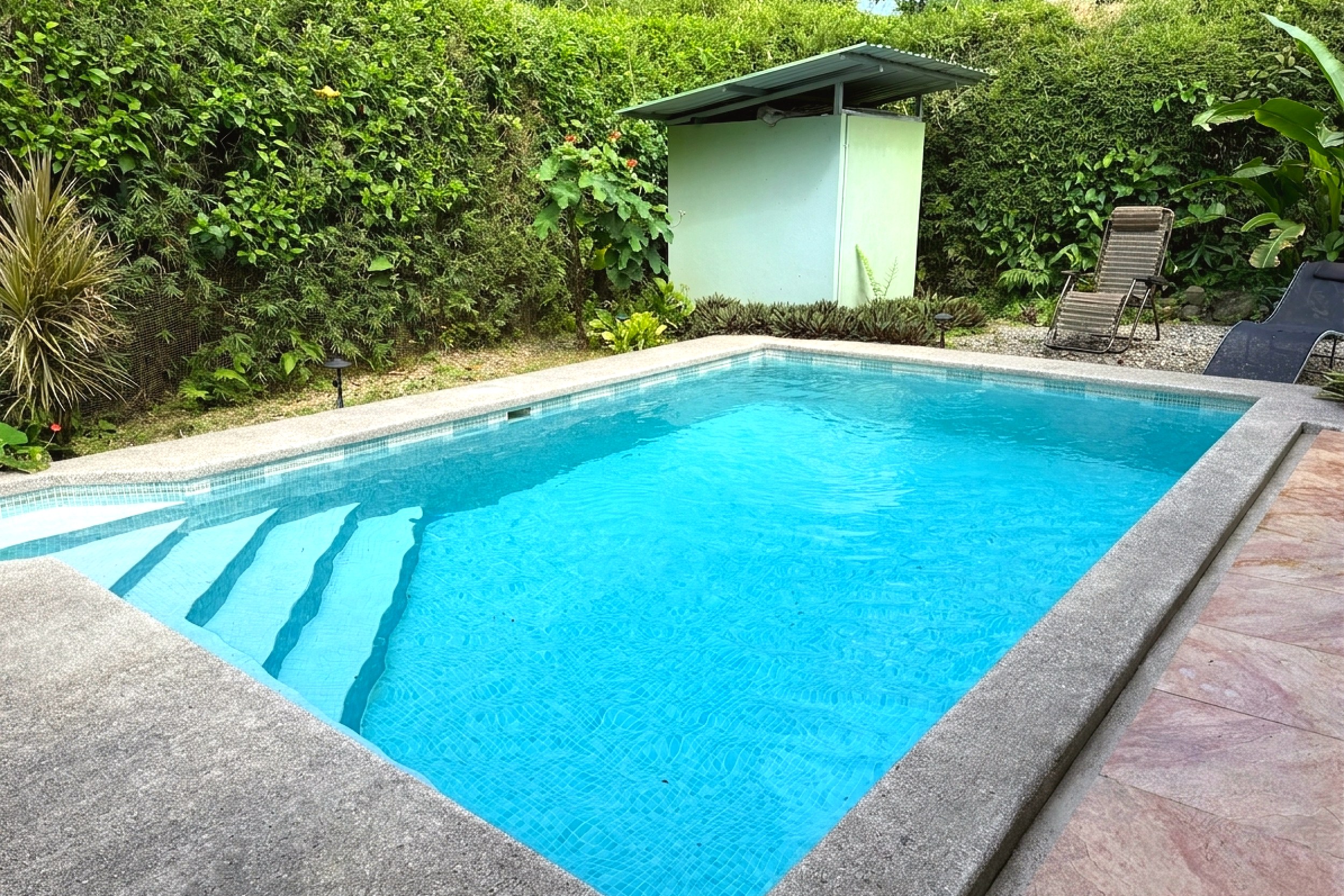 Private Pool & Lounge Area Serene Jungle Sanctuary private pool with entry steps and lounge chairs in Ojochal, Costa Rica