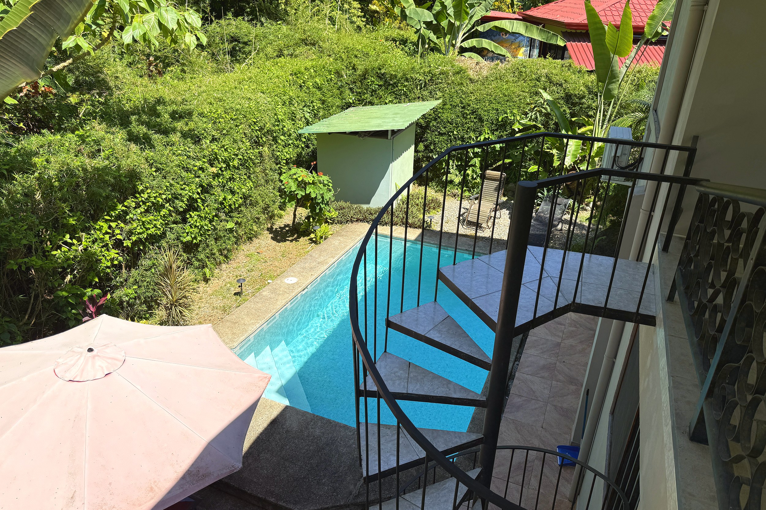 Private Pool & Spiral Stairs Jungle Sanctuary pool with spiral staircase and lush greenery in Ojochal, Costa Rica