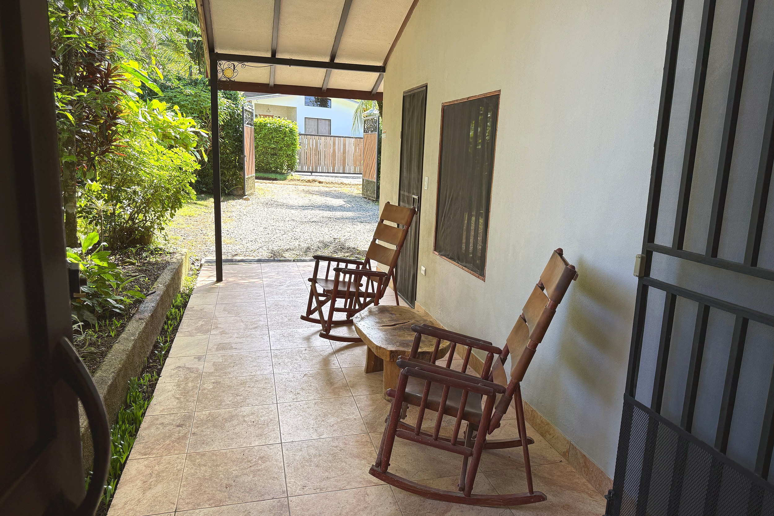 Covered Terrace with Rocking Chairs Jungle Sanctuary covered tiled terrace with rocking chairs in Ojochal, Costa Rica
