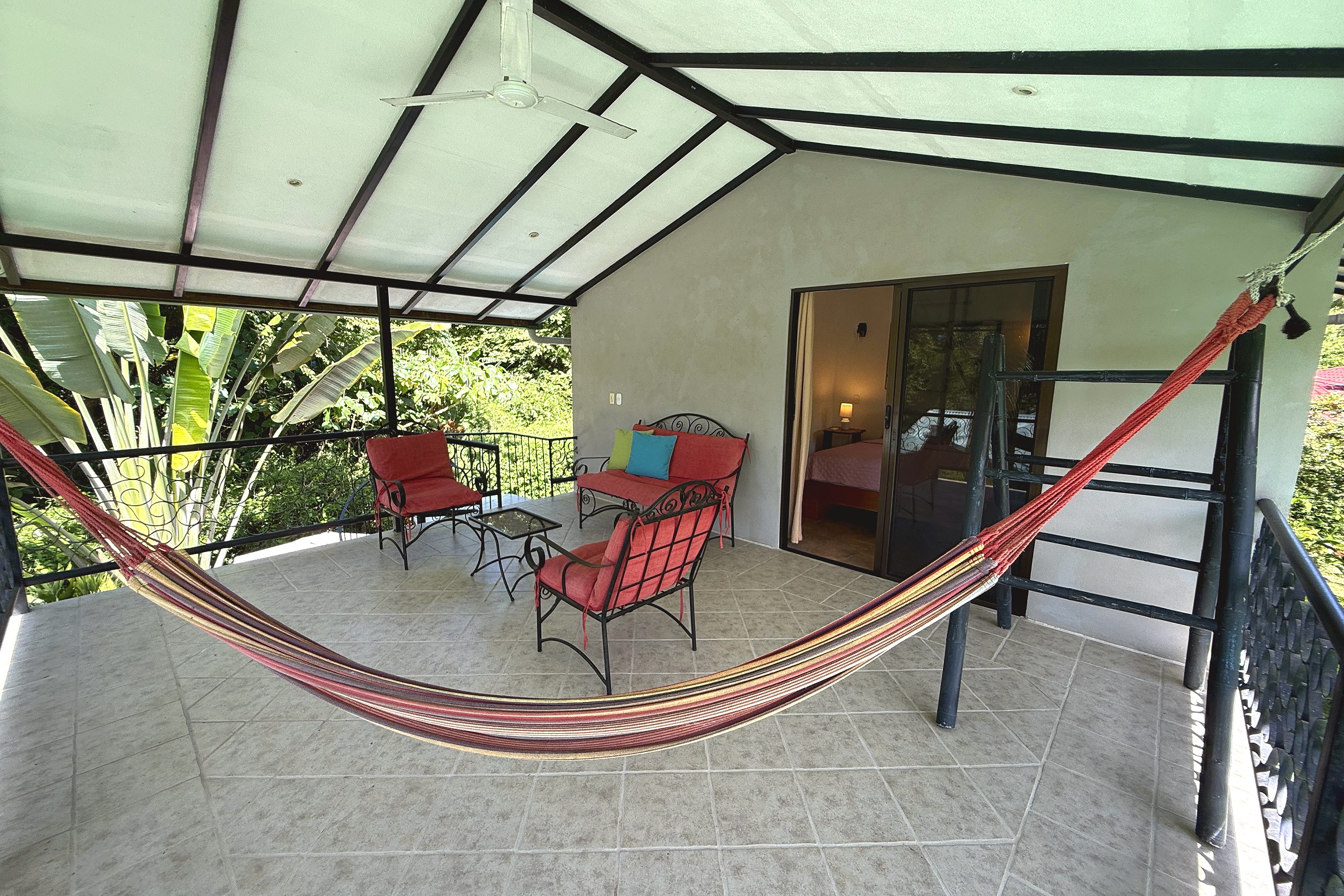 Balcony Hammock Retreat Jungle Sanctuary covered balcony with hammock and lounge seating in Ojochal, Costa Rica