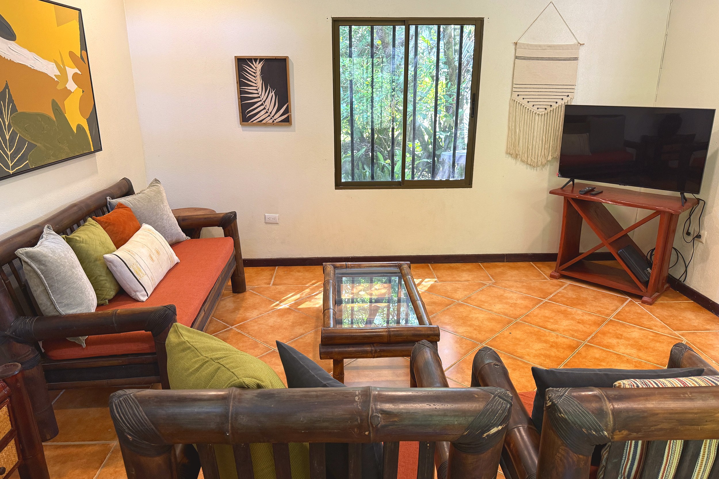 Cozy Bamboo Living Room Jungle Sanctuary living room with bamboo sofas and jungle-view window in Ojochal, Costa Rica