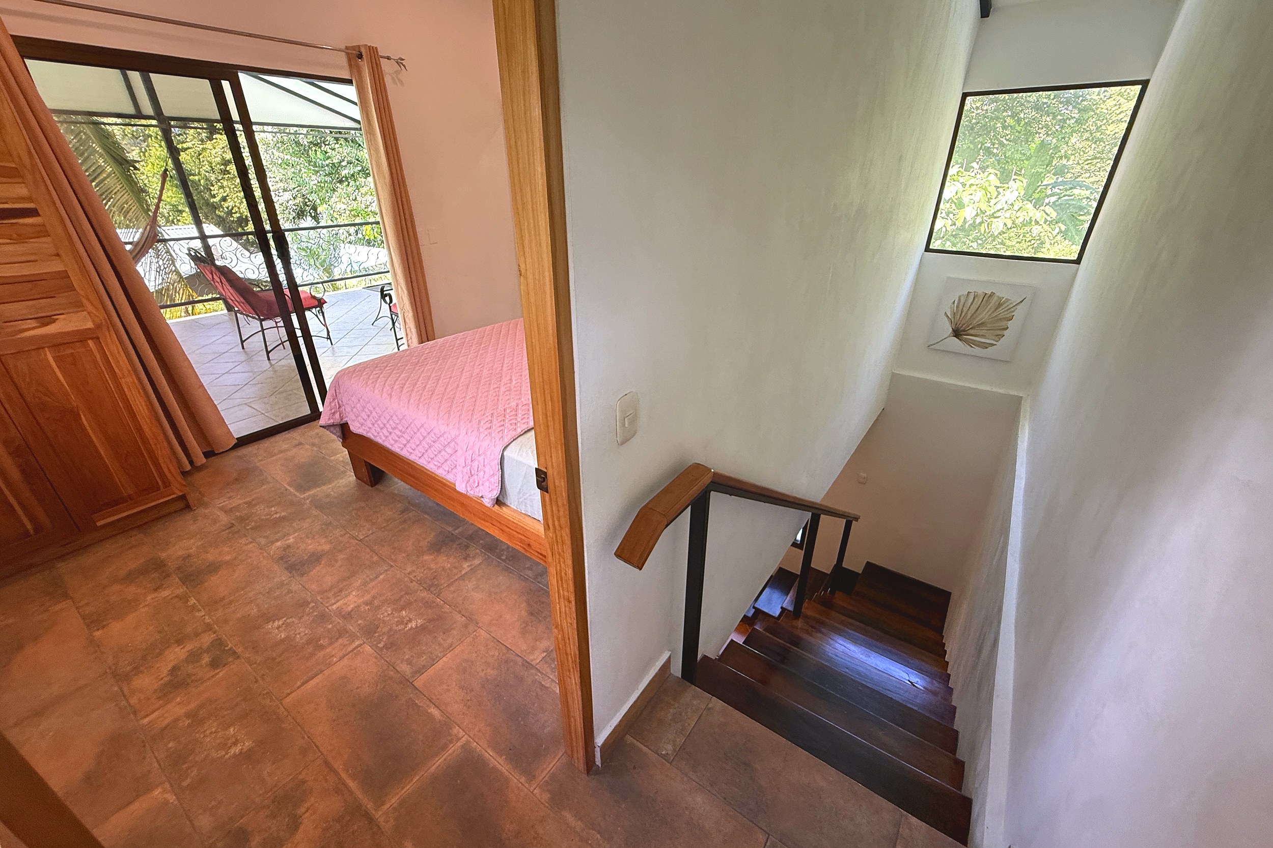 Master Bedroom & Staircase Jungle Sanctuary master bedroom with terrace access and staircase view in Ojochal, Costa Rica