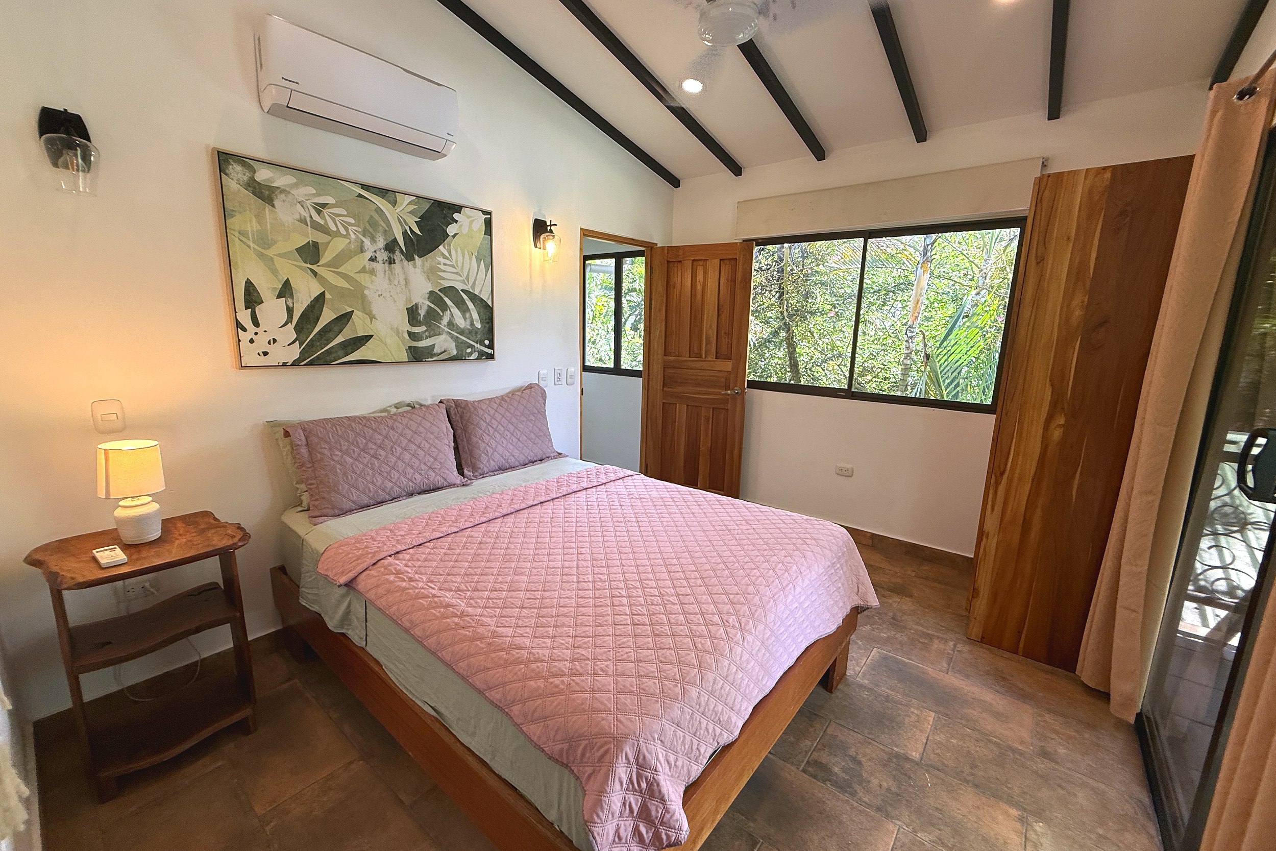 Master Bedroom Jungle Views Jungle Sanctuary master bedroom with pink bed, jungle-view window in Ojochal, Costa Rica