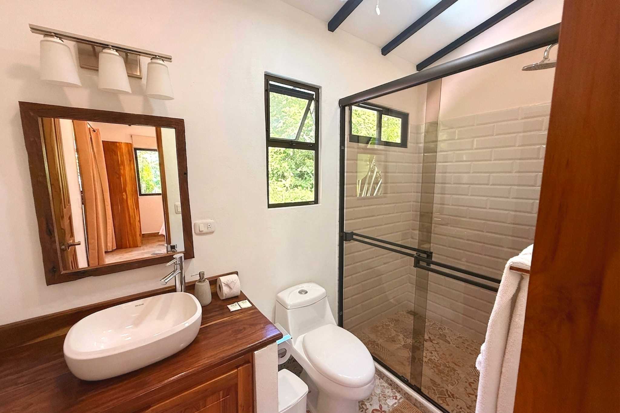 Master Bathroom Vanity & Shower Serene Jungle Sanctuary vessel sink vanity and glass-enclosed shower in Ojochal, Costa Rica