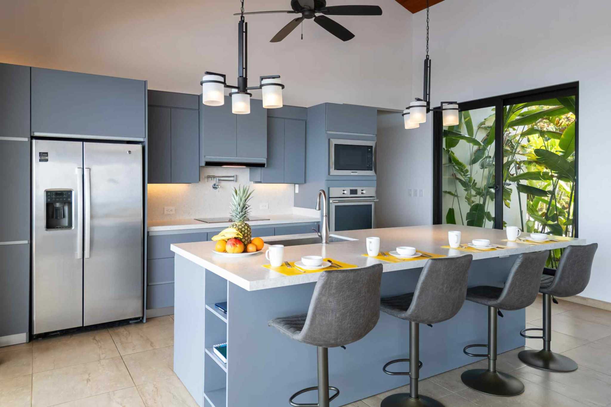 72497-11 Luxury Home kitchen island with bar seating and tropical garden view in Ojochal, Costa Rica