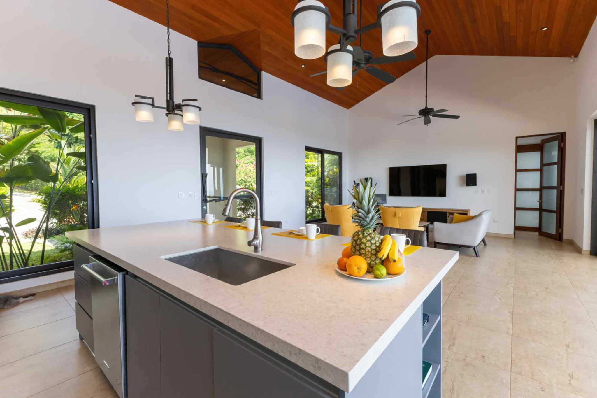 72497-13 Luxury Home kitchen island with quartz counter and open living area in Ojochal, Costa Rica