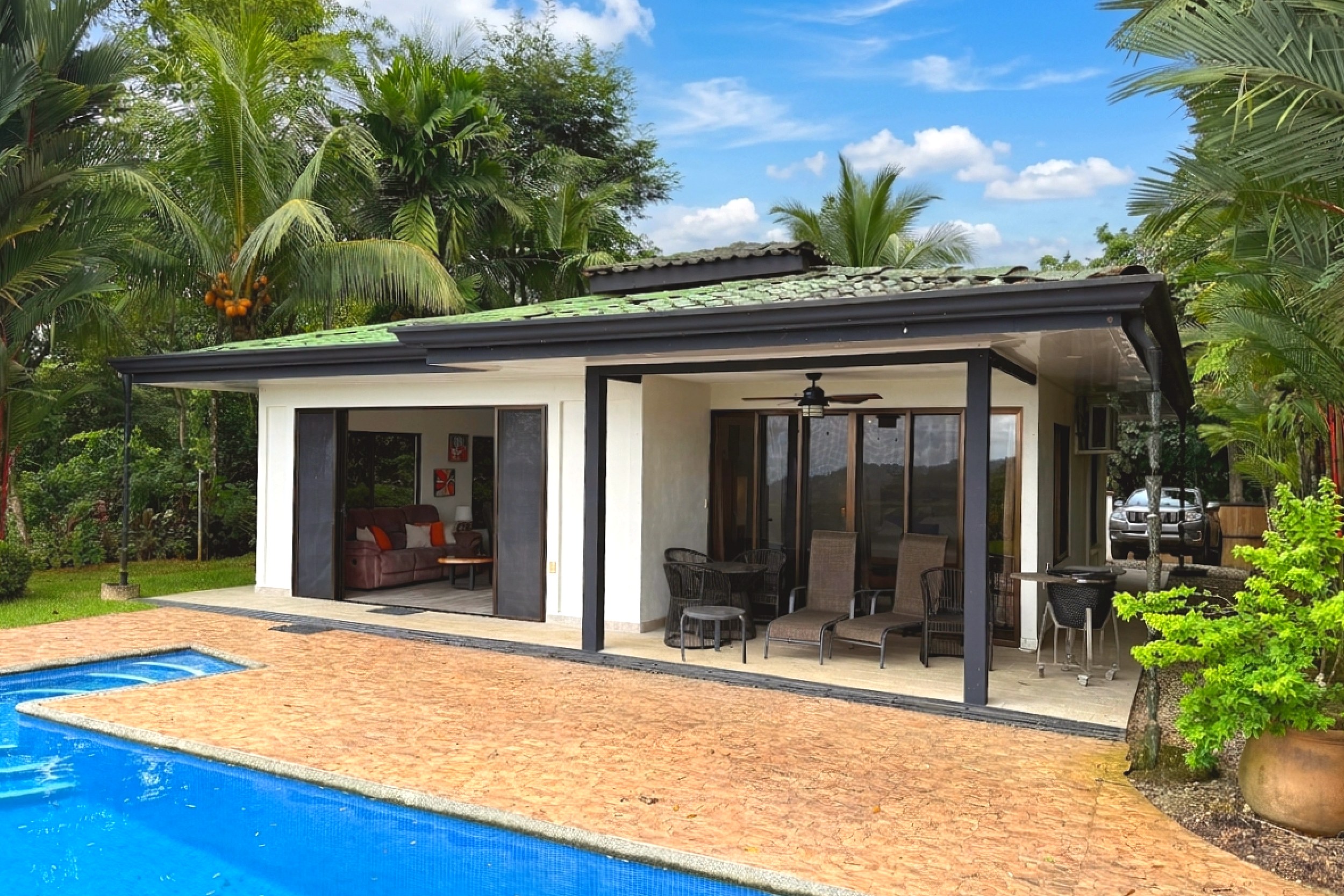 Poolside Covered Patio Tropical Pool House covered patio and pool with tile roof in Costa Rica