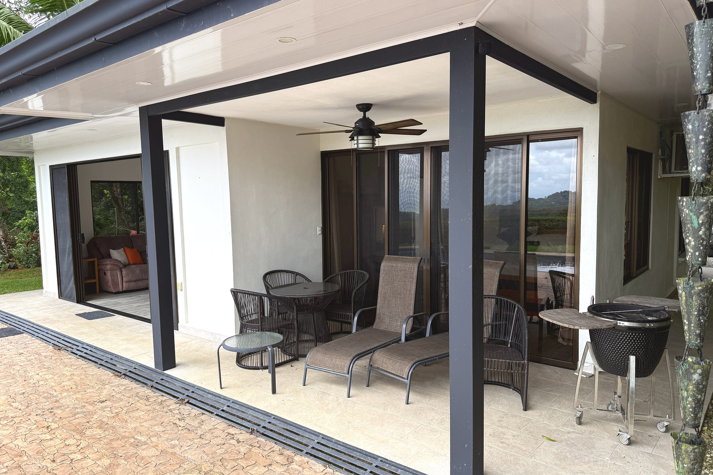Covered Patio & Lounge Modern Home covered patio with lounge chairs, dining set, and grill in Costa Rica