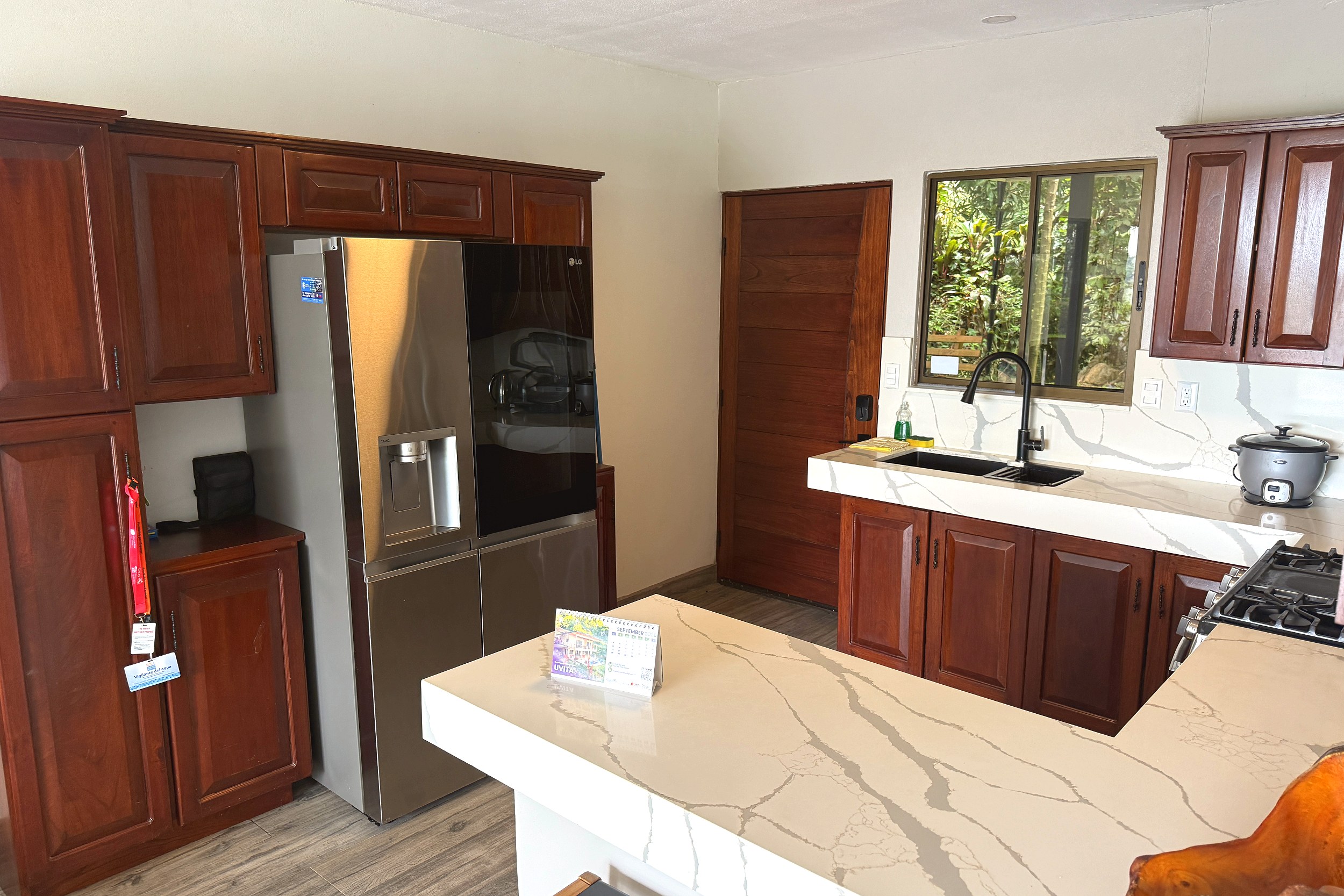 Kitchen with Quartz Counters Wooden Cabin Kitchen with stainless fridge and quartz countertops in Costa Rica