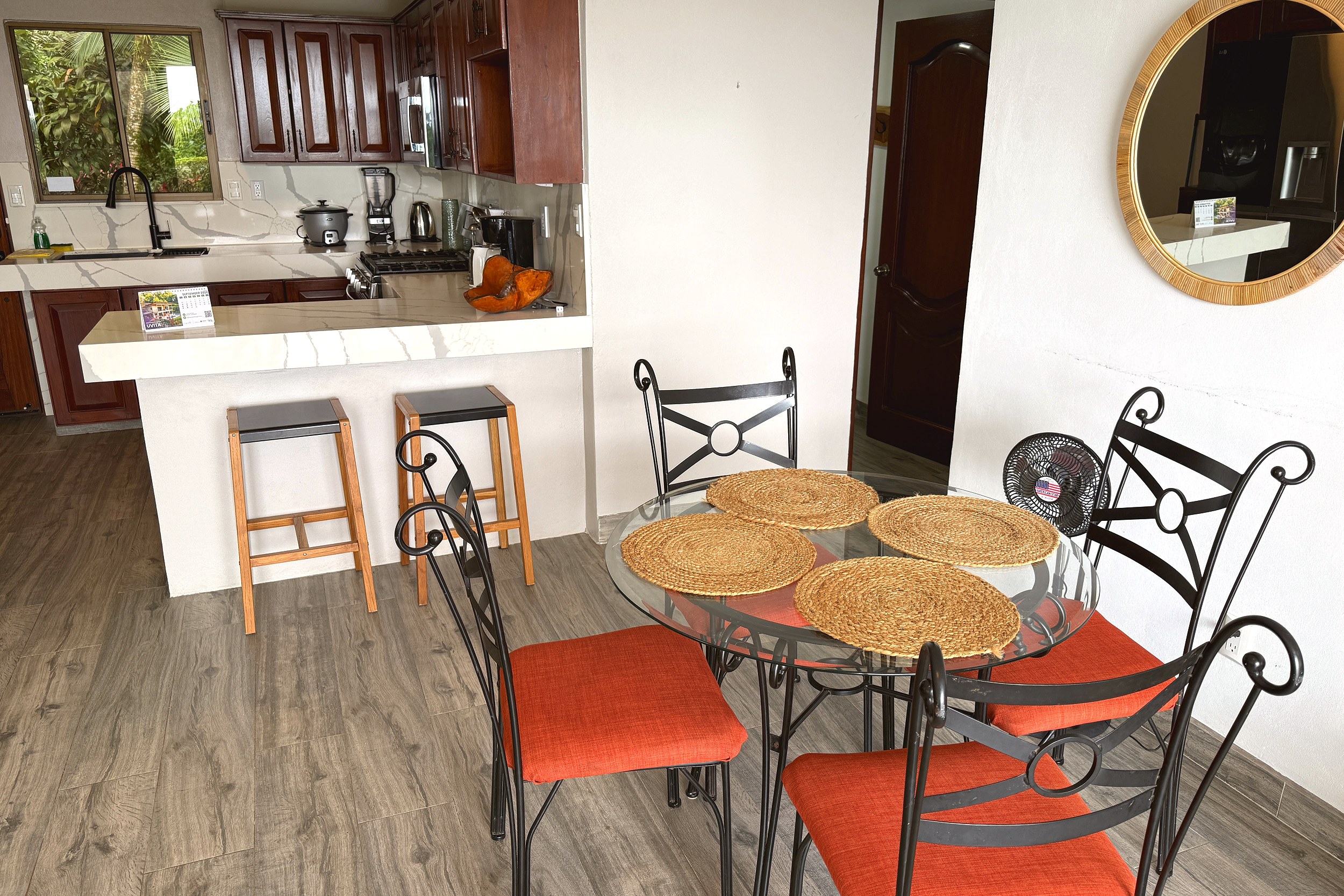 Dining Area & Breakfast Bar Kitchen Condo dining table with woven placemats and bar stools in Costa Rica