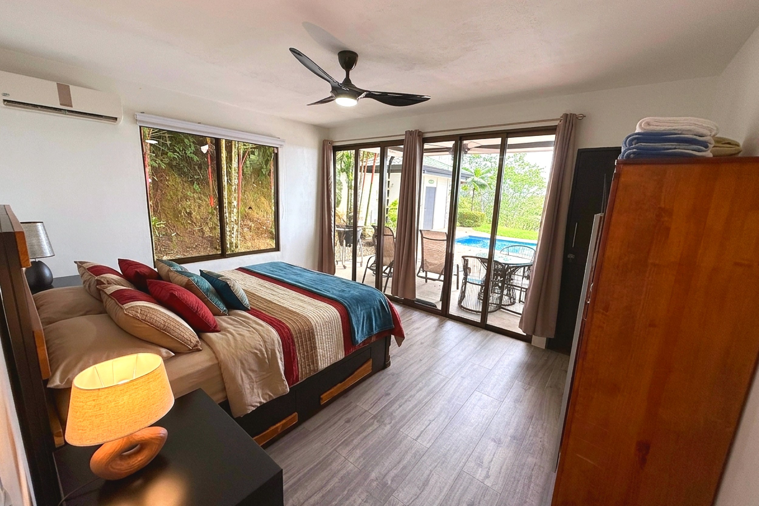 Master Bedroom & Pool View Master bedroom with king bed, pool view patio doors, ceiling fan in Costa Rica