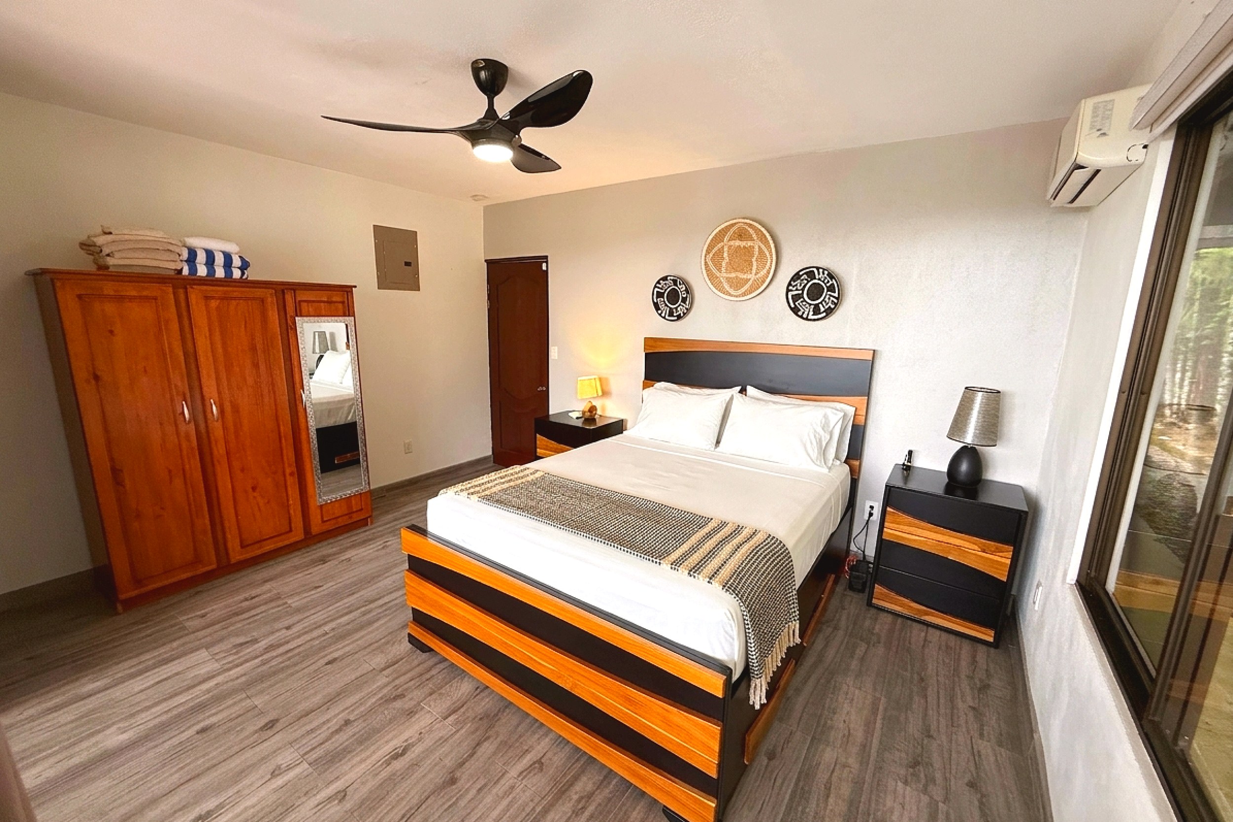 Main Guest Bedroom Guest House bedroom with striped wood bed frame and wardrobe in Costa Rica
