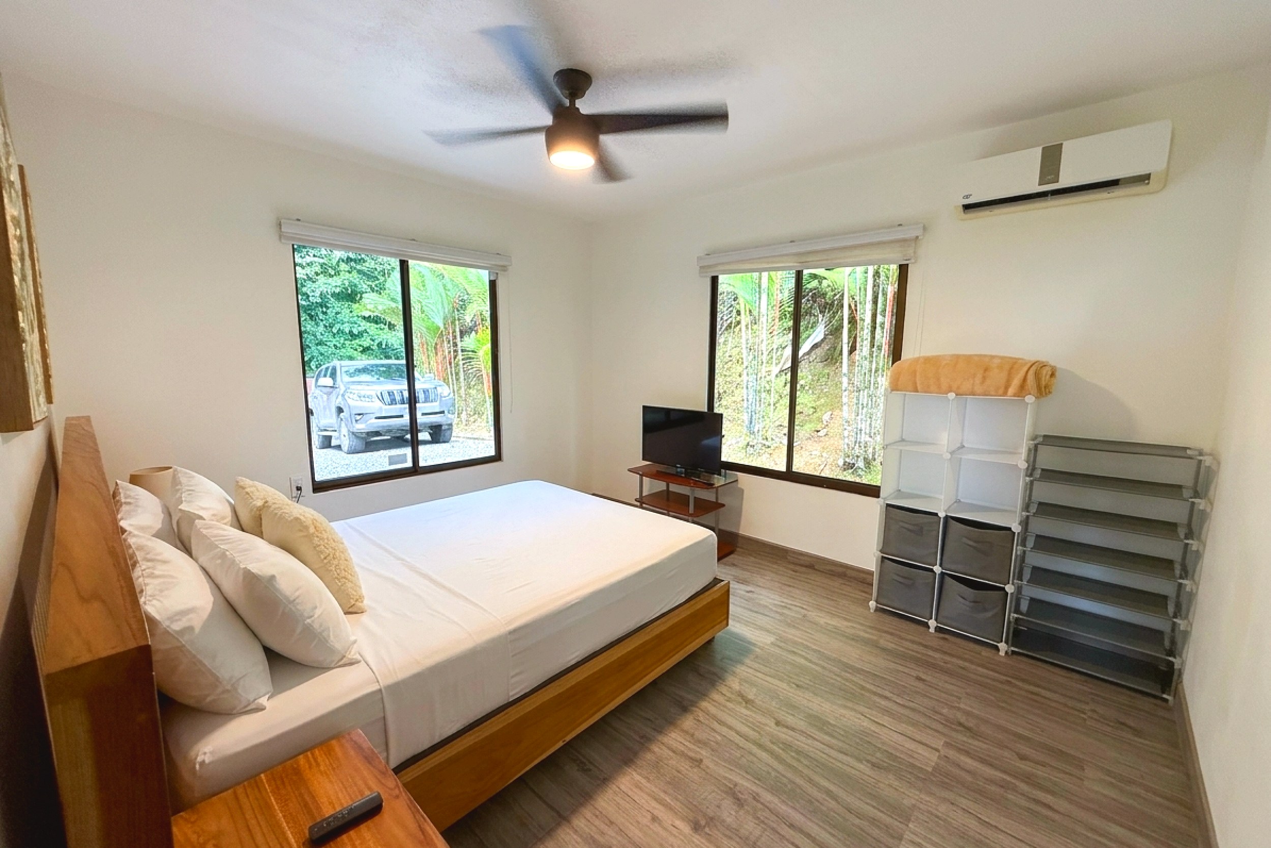 Main Guest Bedroom Guest bedroom with queen bed, ceiling fan, AC unit, and storage shelves in Costa Rica