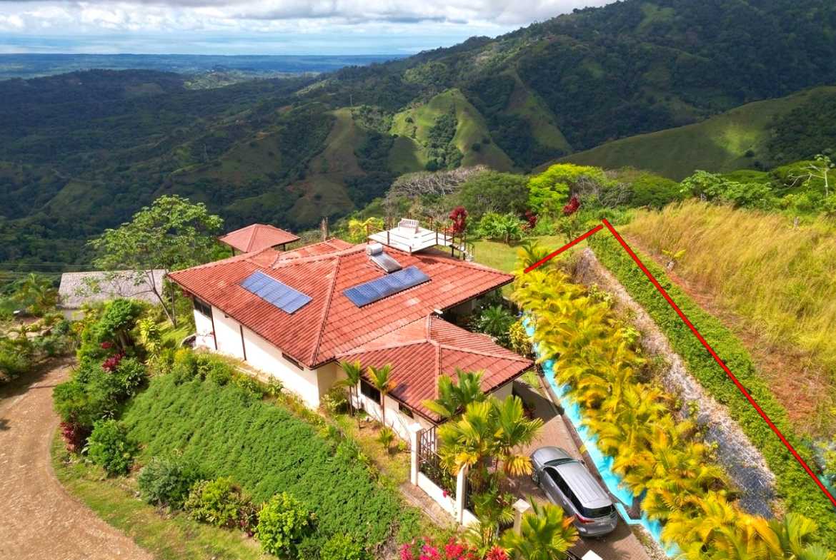 Aerial view of a hillside villa with solar panels and mountain views in Toucan Valley, Costa Rica.
