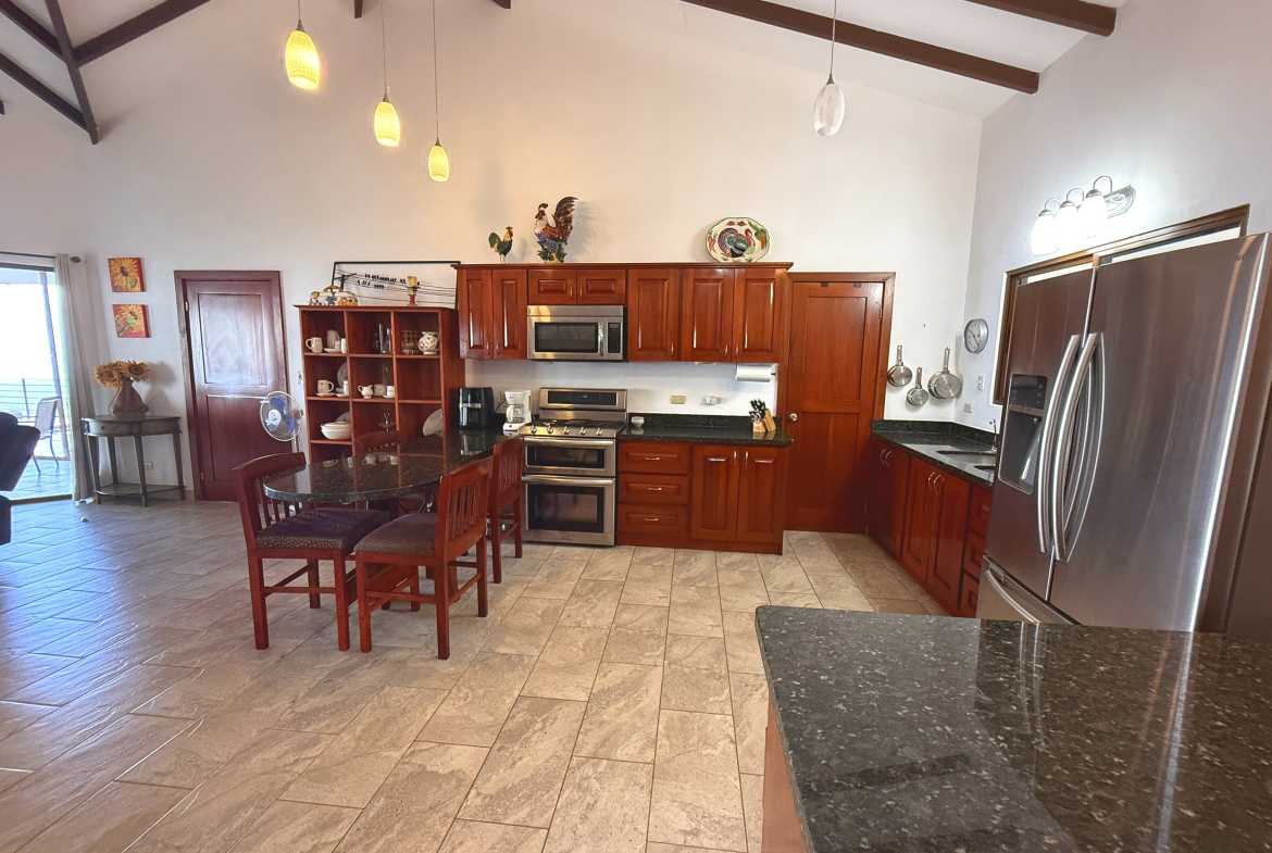 Ocean-View 3-Bedroom Home modern kitchen with wood cabinets in Toucan Valley/Osa Mountain Village, Costa Rica