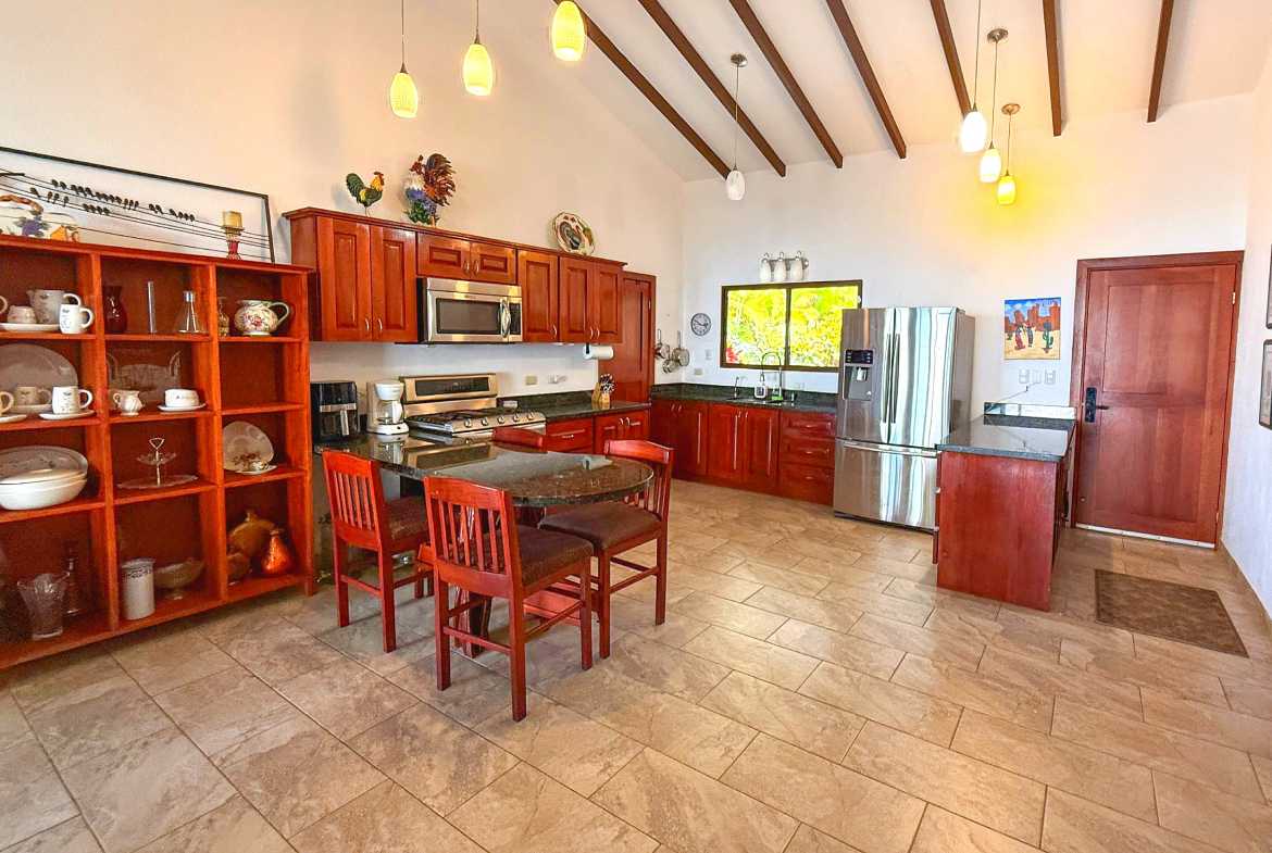 Ocean-View 3-Bedroom Home spacious kitchen with wood cabinets in Toucan Valley/Osa Mountain Village, Costa Rica
